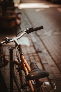 Close-up of bicycle on street in city