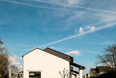 Low angle view of house against blue sky