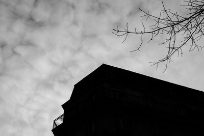 Low angle view of building against cloudy sky