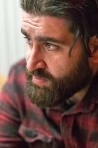 Close-up of thoughtful bearded man looking away