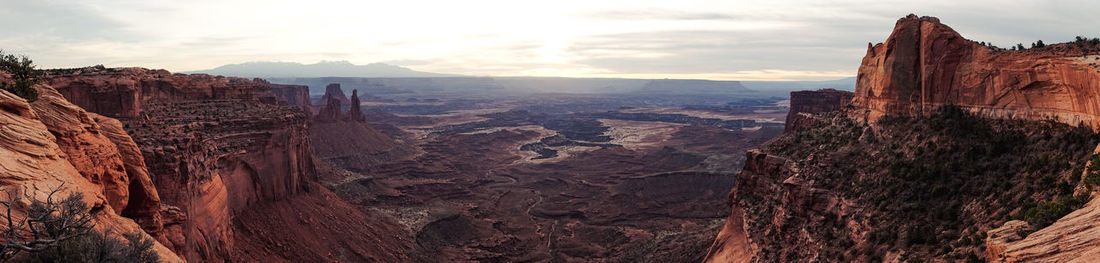 Panoramic view of rock formations against cloudy sky