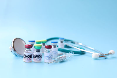 Close-up of objects on table against blue background