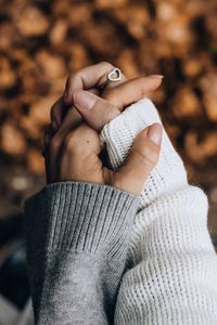 Close-up of human hand holding hands during winter