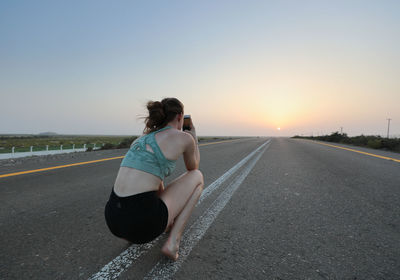 Full length of woman walking on road