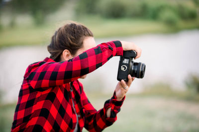 Full length of woman taking photographs 