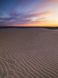 Sunset sky over rippled sand