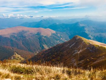 Scenic view of mountains against cloudy sky