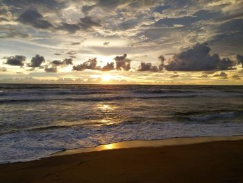 Scenic view of beach against sky during sunset