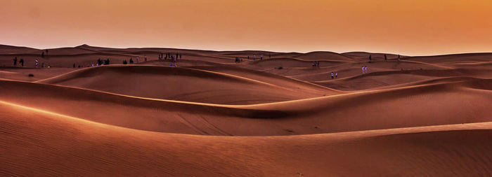 Scenic view of desert against sky during sunset