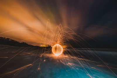 Light painting against sky at night