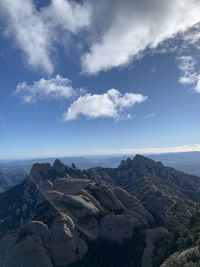 Scenic view of sea and mountains against sky