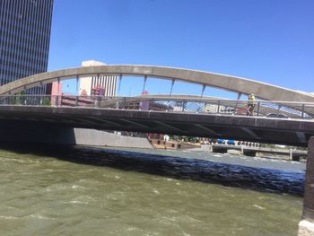 Low angle view of bridge against blue sky