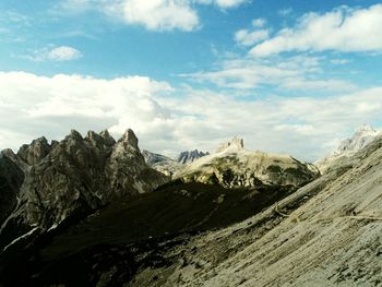 Scenic view of mountains against cloudy sky