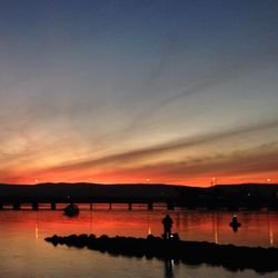 Scenic view of river at sunset
