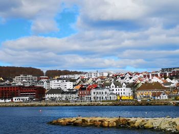 Town by sea against sky in city