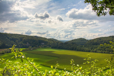 Scenic view of golf course against sky