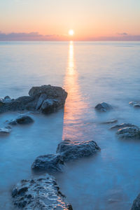 Scenic view of sea against sky during sunset