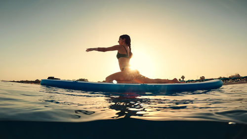 Low section of man swimming in sea