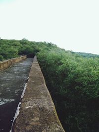 Surface level of footpath against clear sky