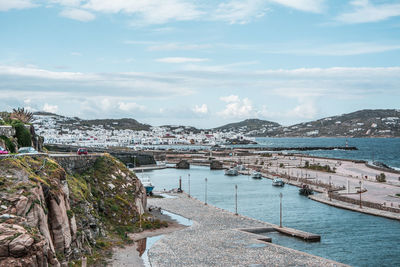 Scenic view of sea and cityscape against sky