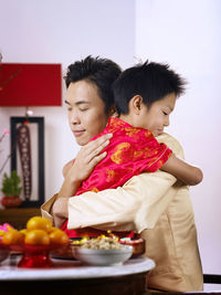 Father embracing son during festival