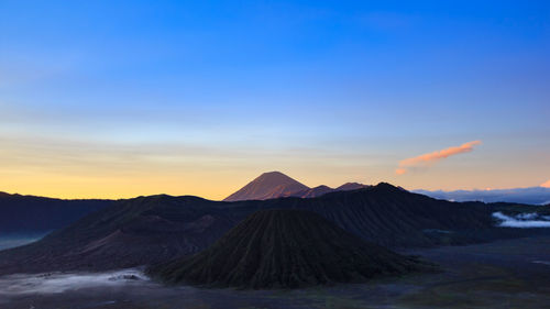 Scenic view of mountain range against sky during sunset