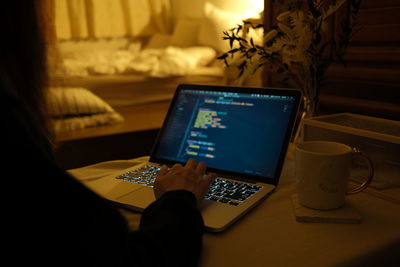 High angle view of person using laptop on table at home