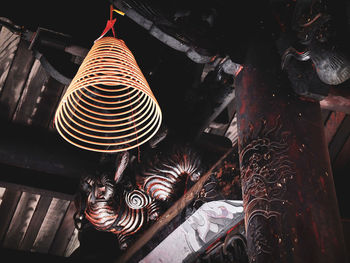 High angle view of illuminated lighting equipment hanging on ceiling