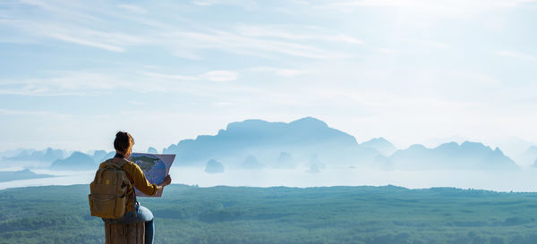 Rear view of man standing on mountain