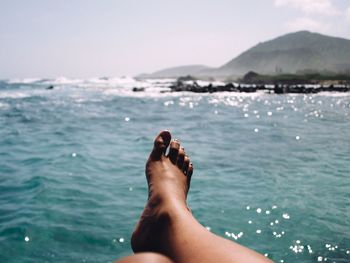 Low section of woman in sea