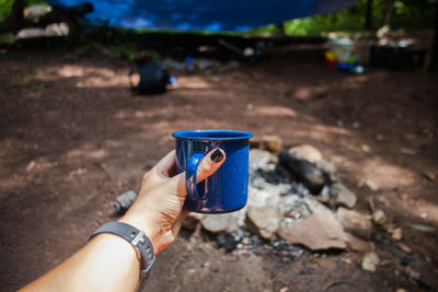 Close-up of hand holding coffee cup