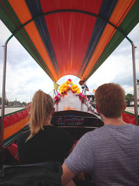 Rear view of couple traveling in boat