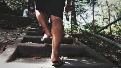 Low section of woman walking on steps