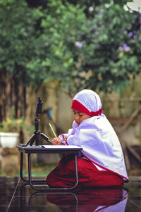 Side view of man using mobile phone