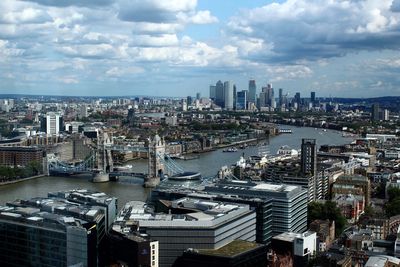 High angle view of buildings by river against sky