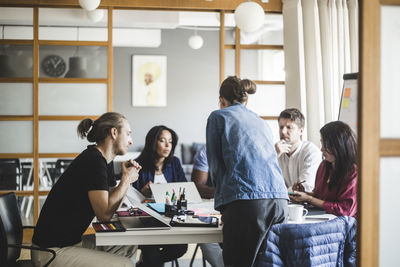 Businesswoman planning strategy with colleagues in meeting at board room