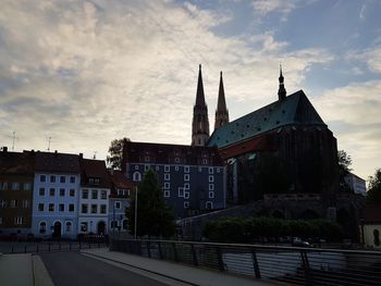 Low angle view of buildings against sky at sunset