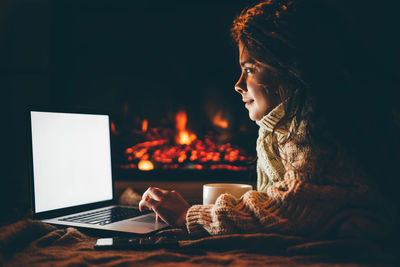 Young woman using laptop at home