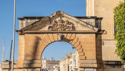 Low angle view of historical building against blue sky