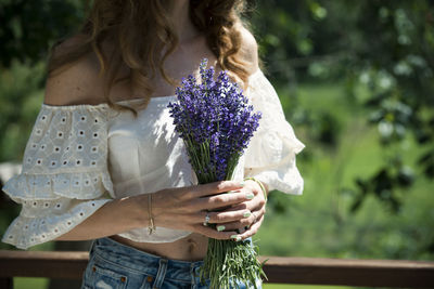 Woman holding flower bouquet