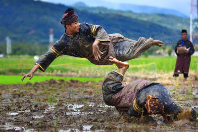 People on field against mountain