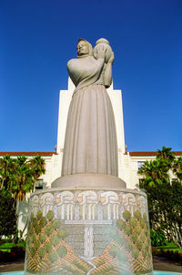 Low angle view of statue against blue sky