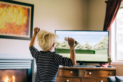 Young boy playing video games on tv