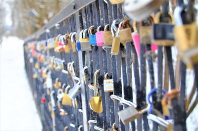 Close-up of padlocks hanging on railing