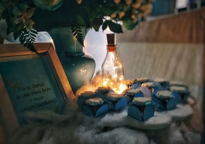 Close-up of illuminated wine bottles on table