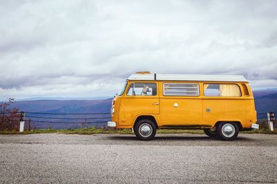 Vintage car on road against sky