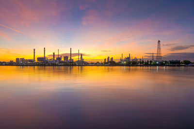 View of factory against sky during sunset