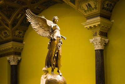 Low angle view of statue against temple