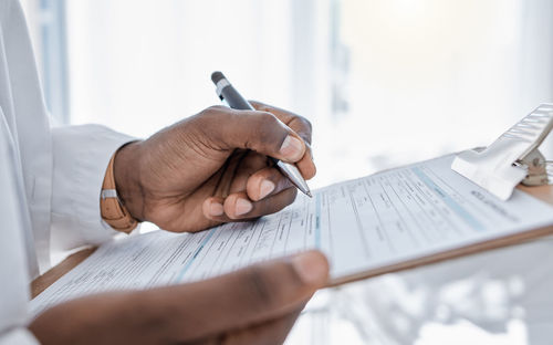 Cropped hands of man working on table