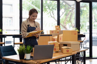 Side view of man using laptop while sitting on table
